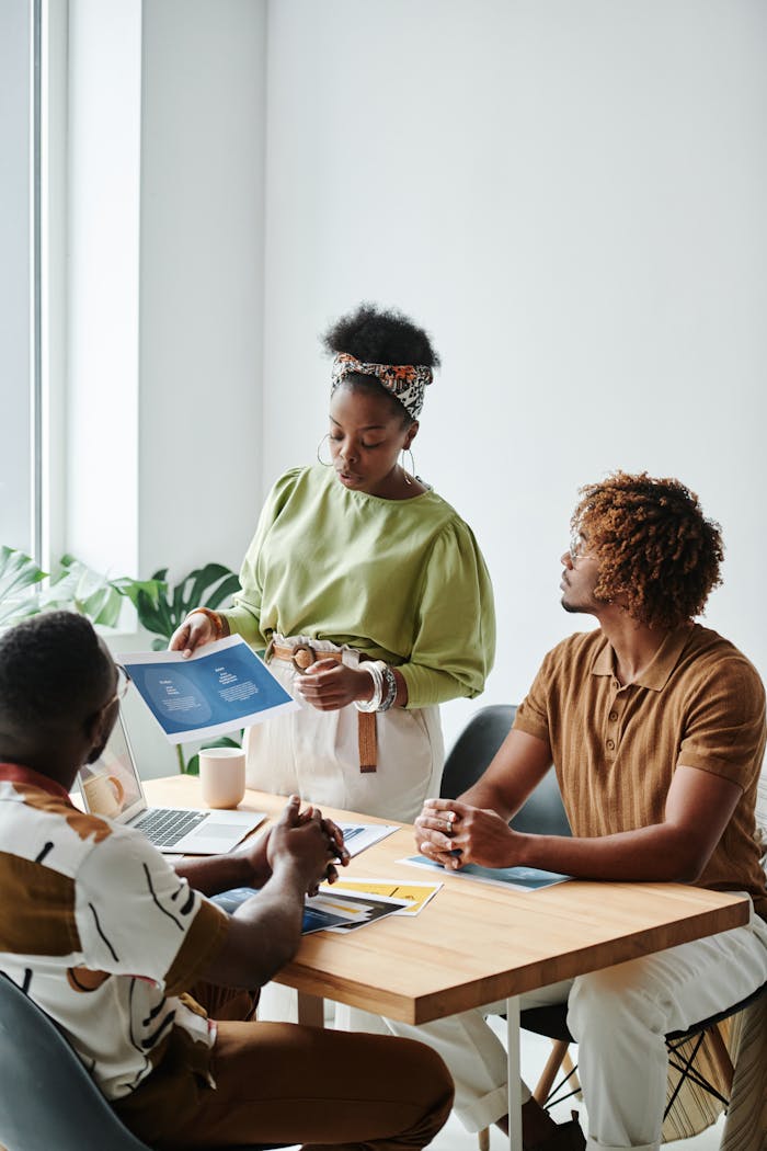Diverse team collaborating in a bright, modern office setting with documents.